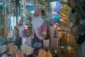 Three dolls in the form of Santa Clauses in pink costumes and caps surrounded by New Year`s decor Royalty Free Stock Photo