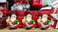 Three dolls of Santa Claus with a gift, Christmas figurine interior decoration. Christmas sale Royalty Free Stock Photo