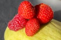 Three domestic strawberry, rapsbery on mango plate