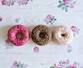 Three donuts on a background in the style of a shabby chic. Royalty Free Stock Photo