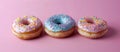 Three Donuts With Sprinkles on Pink Background Royalty Free Stock Photo