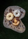 Three doughnuts covered with Cookies and creme, Almendras and Choco peanut butter Royalty Free Stock Photo