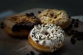 Three doughnuts covered with Cookies and creme, Choco peanut butter and Almendras Royalty Free Stock Photo