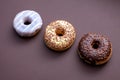 three doughnuts isolated on brown background Royalty Free Stock Photo