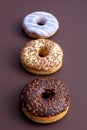 three doughnuts isolated on brown background Royalty Free Stock Photo