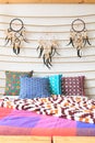 Three dreamcatchers above cushions