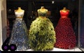 Three dresses with clear Christmas theme in storefront