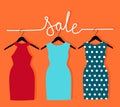 Three dresses on a hanger and an inscription sale. Vector illustration with sale of clothes for woman