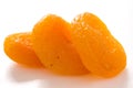 Three dried apricots on white surface Royalty Free Stock Photo