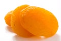 Three dried apricots on white surface Royalty Free Stock Photo