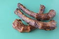 Three Dried turkey neck on a turquoise background