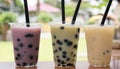 Three drinks with black straws
