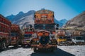 Three drivers sitting on a bright orange truck