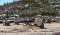 Three dump trucks with a bulldozer and an excavator Royalty Free Stock Photo