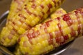 Of three ears of corn garnished with ketchup Royalty Free Stock Photo