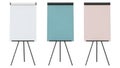 Three easels with blank canvases in white, blue, and pink Royalty Free Stock Photo