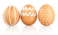 Natural isolated eggs. Three Easter brown eggs decorated with patterns of white paint