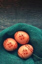 Three Easter chicken brown eggs in a nest of green color from fabric Royalty Free Stock Photo