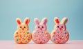 Three Easter Cookies In The Shape Of Cute Bunnies, Decorated With Icing On A Pastel Blue Background. Easter Culinary Banner