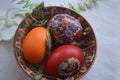 Three Easter eggs in a brown bowl. Royalty Free Stock Photo