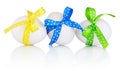 Three Easter eggs with festive bow isolated on white background Royalty Free Stock Photo