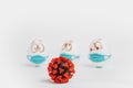 Three easter eggs in medical masks on a white background in front of a model