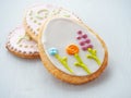 Three easter sugar cookies decorated with royal icing. Ester treat upon wooden table.