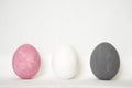 Three easter white grey pink eggs
