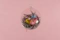 Three eggs in a floating glass nest. Pink background. Creative Easter concept