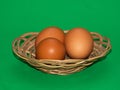 Three eggs in the palte over green, isolated