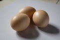 Three eggs are placed on a white background Royalty Free Stock Photo