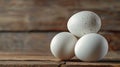 Three eggs stacked on wooden surface Royalty Free Stock Photo