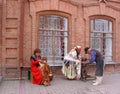 Three elderly people in medieval costumes depict artisans at the festival Royalty Free Stock Photo