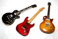 Three beautiful electric guitars displayed on a white background Royalty Free Stock Photo