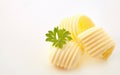 Three elegant curls of butter with fresh parsley Royalty Free Stock Photo