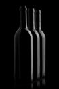 Three elegant wine bottles in black background Royalty Free Stock Photo