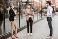 Employers standing in social distance wearing face mask looking at each other and talking