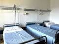 three empty beds in a hospital room