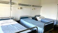 three empty beds in a hospital room