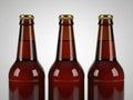 Three empty beer bottles in a row with gold caps Royalty Free Stock Photo