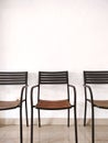 Three empty black cast iron chairs with wooden seats Royalty Free Stock Photo