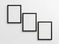 Three empty black framed rectangles mounted on a white wall displaying blank space Royalty Free Stock Photo