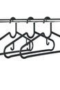 Three empty coat hangers / clothes hangers on a clothes rail Royalty Free Stock Photo