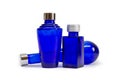 Three empty cobalt blue glass lotions and potions bottles.