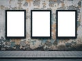 Three empty frames on distressed wall isolated on white background Royalty Free Stock Photo