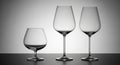 Three Empty Glass Wine and Brandy Glasses on a Dark Surface with Gradient Background clear Royalty Free Stock Photo