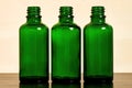 Three empty green glass bottles for women`s cosmetics spray Royalty Free Stock Photo