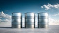 Three empty metal barrels standing side by side on a smooth surface under a partly cloudy sky with soft natural lighting and long Royalty Free Stock Photo