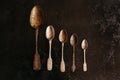 Three empty old silver spoons on dark background. vintage on stone table. Top view. Royalty Free Stock Photo