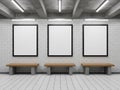 Three empty picture frames hanging on a brick wall with wooden benches underneath isolated on white background Royalty Free Stock Photo